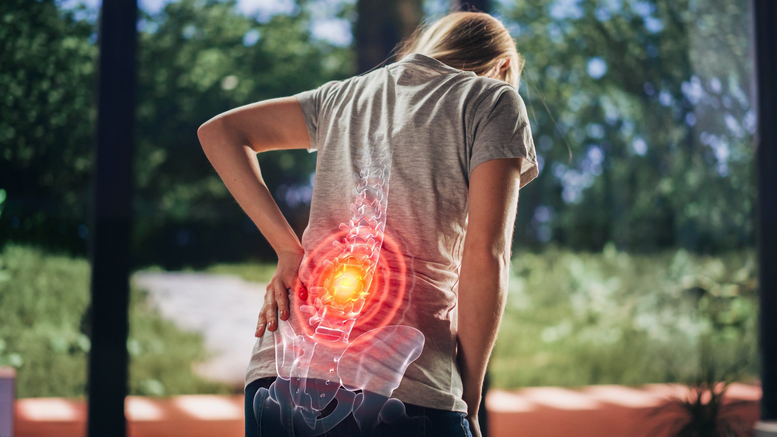 A person experiencing lower back pain, illustrating lumbar spine pain that may require orthopaedic assessment and treatment in Penang.
