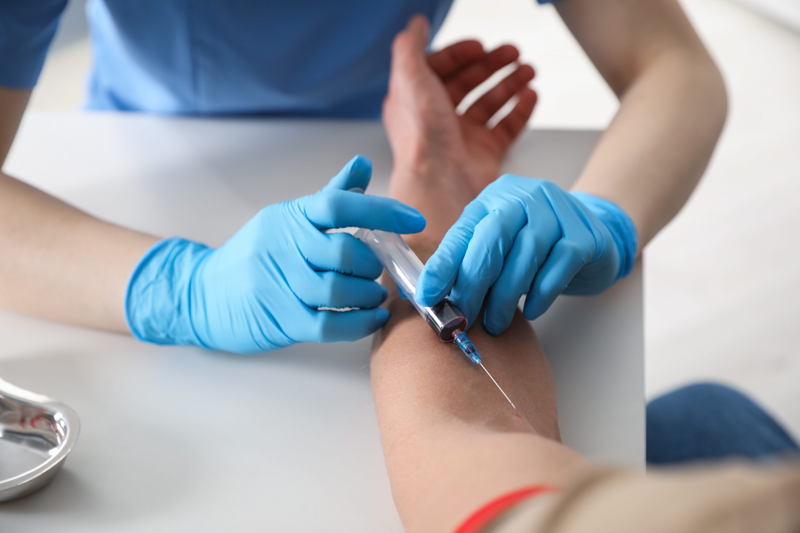 Healthcare professional collecting a blood sample for a Full Blood Examination (FBE), also known as a Complete Blood Count (CBC), during a health screening at Evercare Medical Care Centre in Penang.