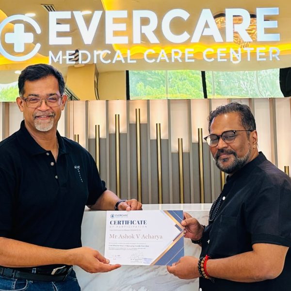 Dr. Ashok V. Acharya receiving a Certificate of Participation at Evercare Medical Care Centre following a clinical exchange on diabetic foot ulcer management in Penang.