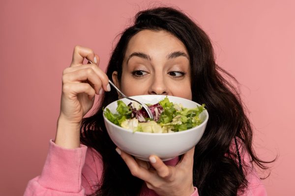 Young,Dark-haired,Woman,Eating,A,Vegetarian,Dish,In,Front,Of